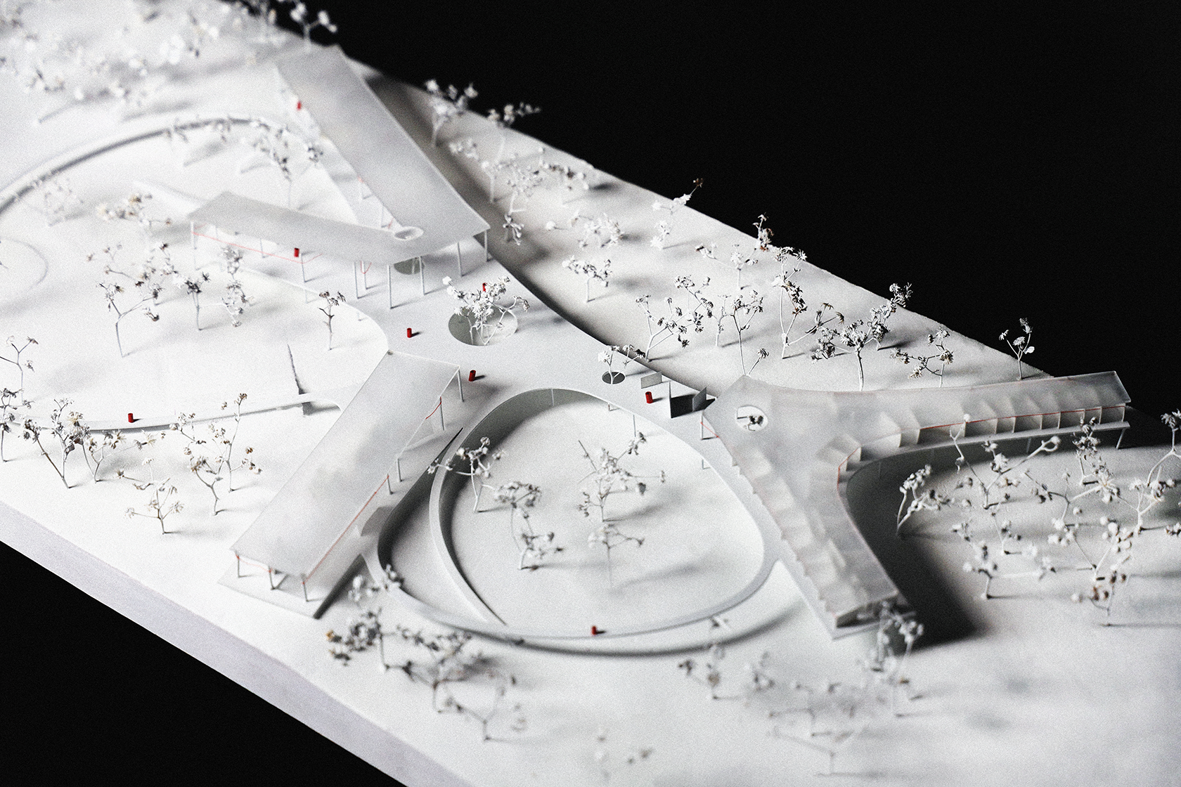 White physical site model of Borinquen Healing Center's curved processional landscape