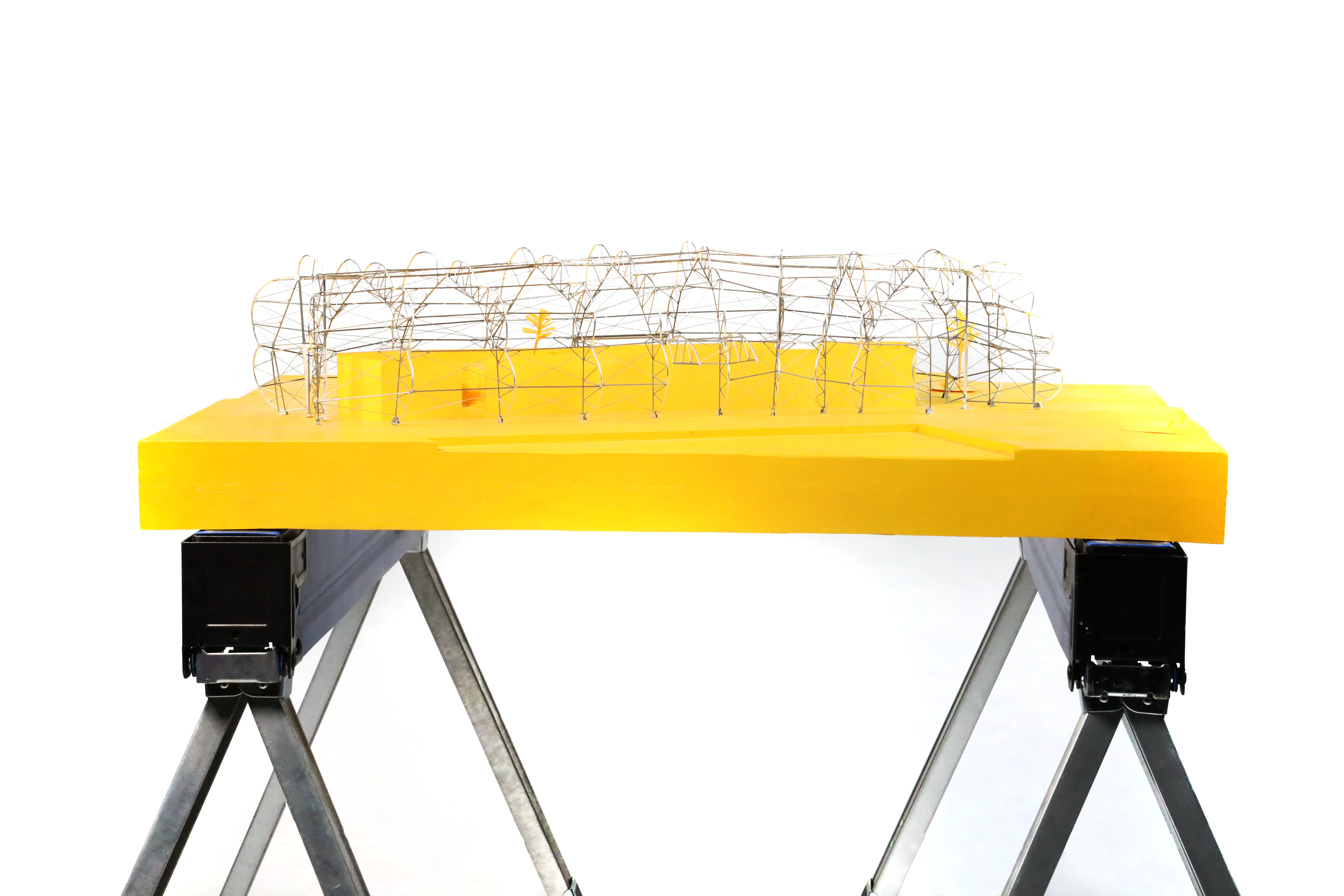Front view of the Design District Canteen wire structural model on an orange site base
