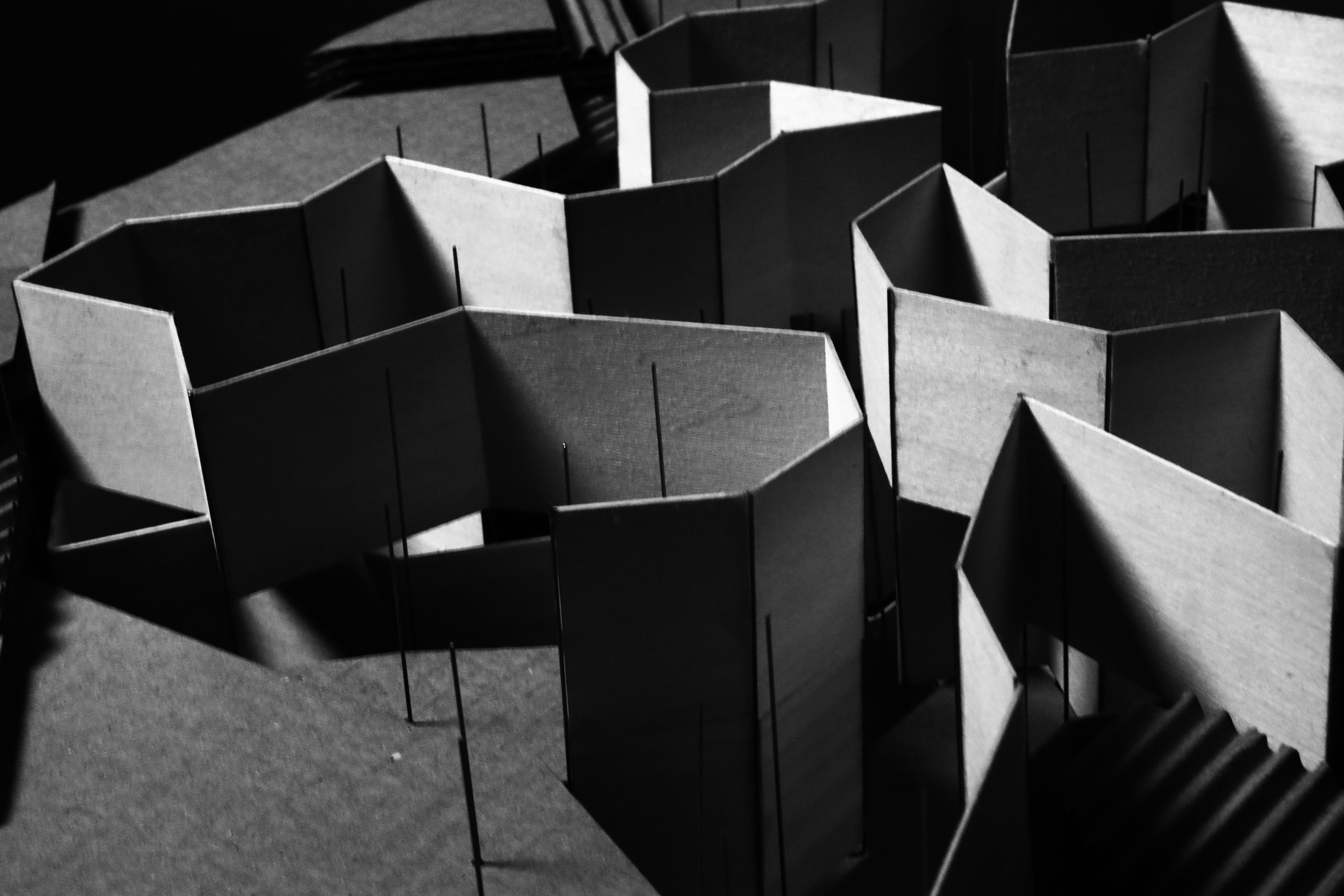 Black-and-white physical model of Woven Pavilion's folded wall enclosures